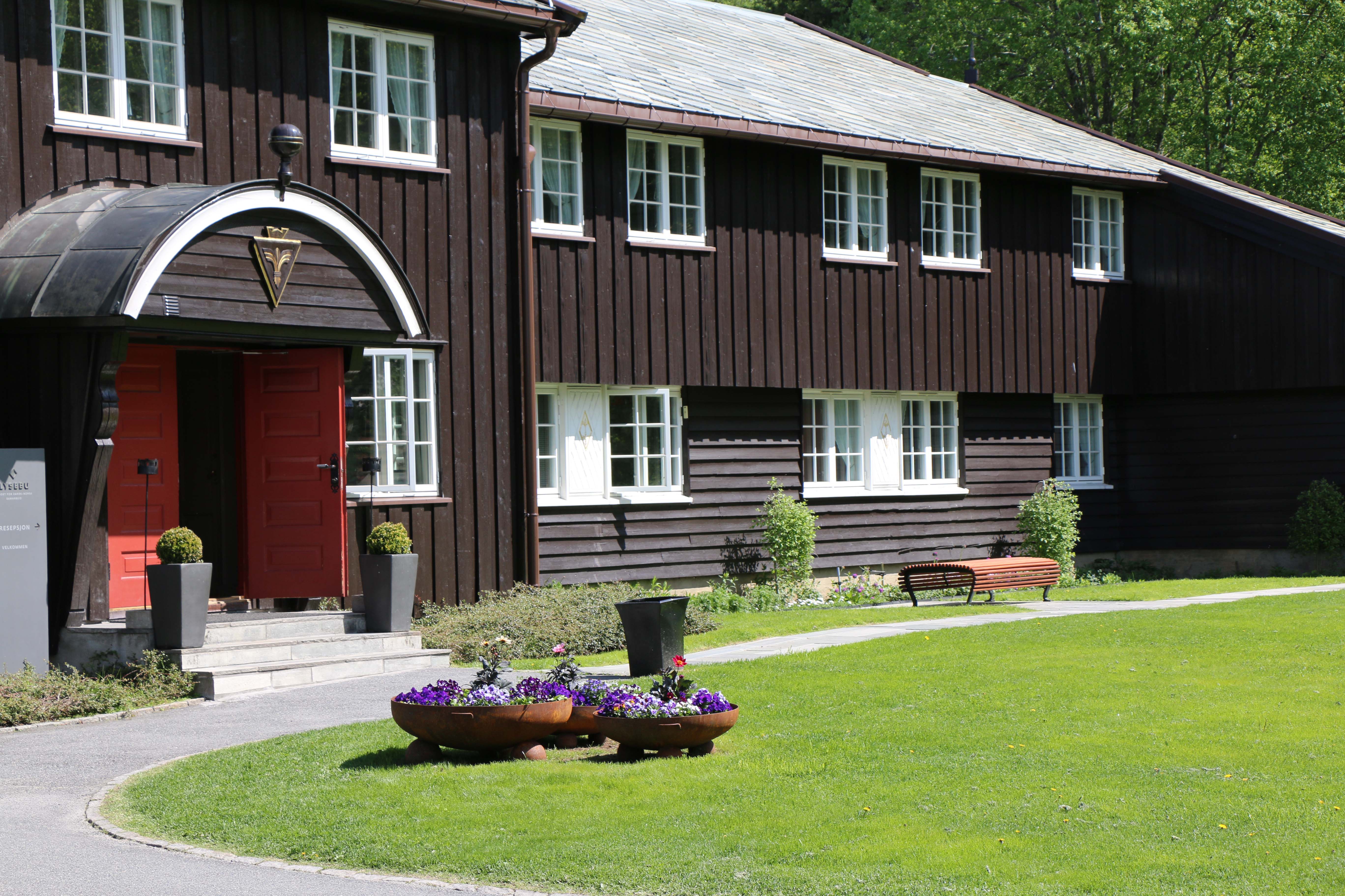 a building with a lawn and flowers in front of it