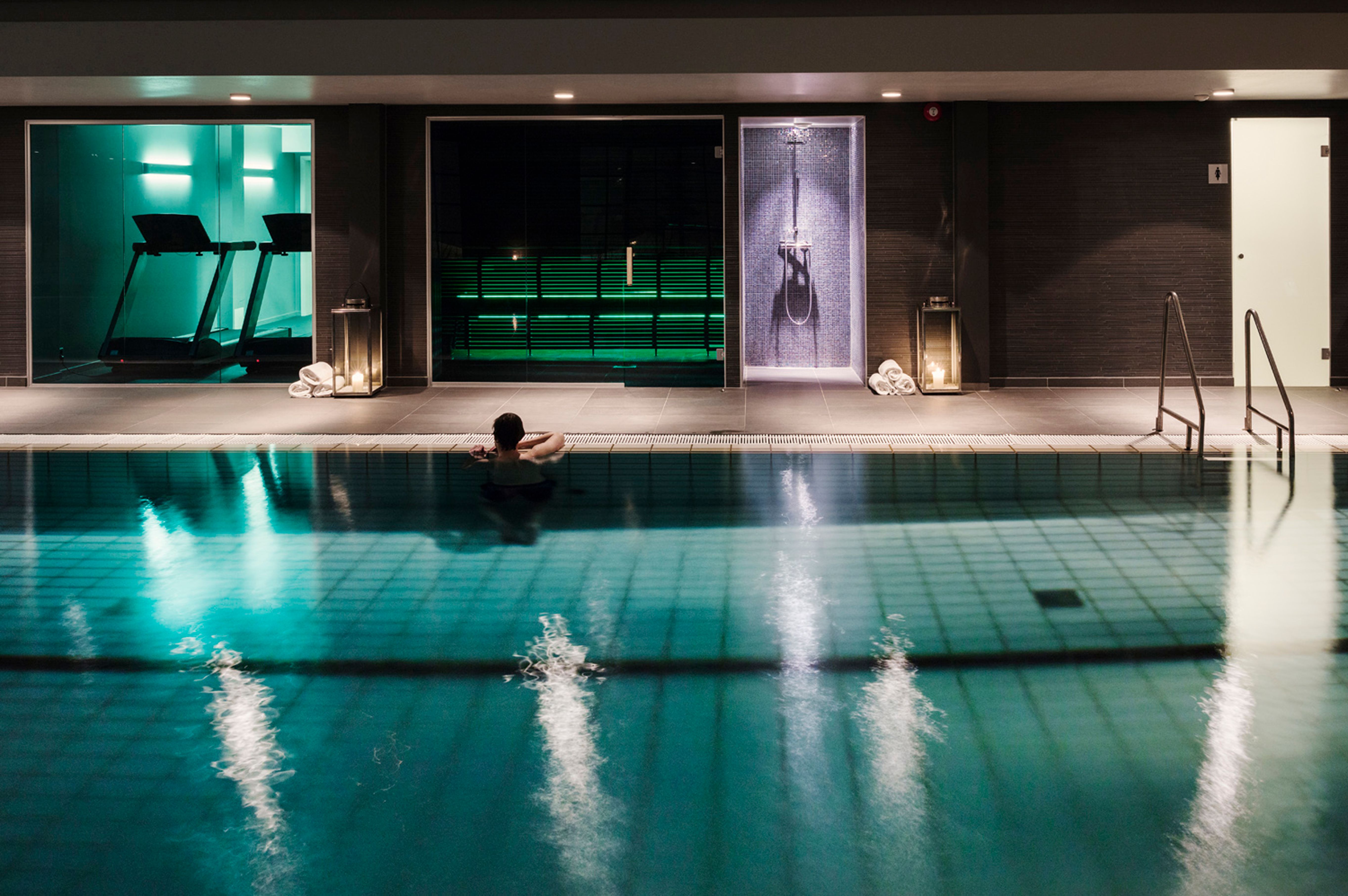 a person sitting in a swimming pool