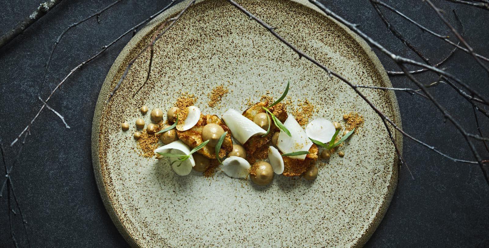 a plate of food on a black surface