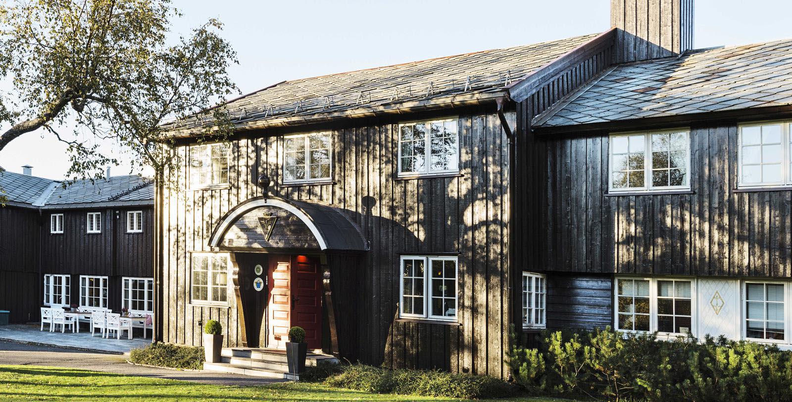 a house with a red door and a tree