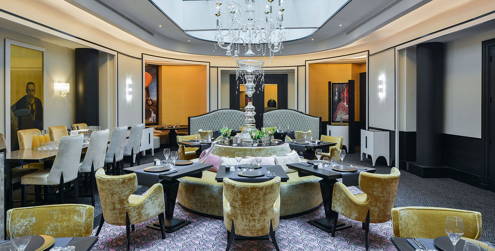 a room with a chandelier and tables