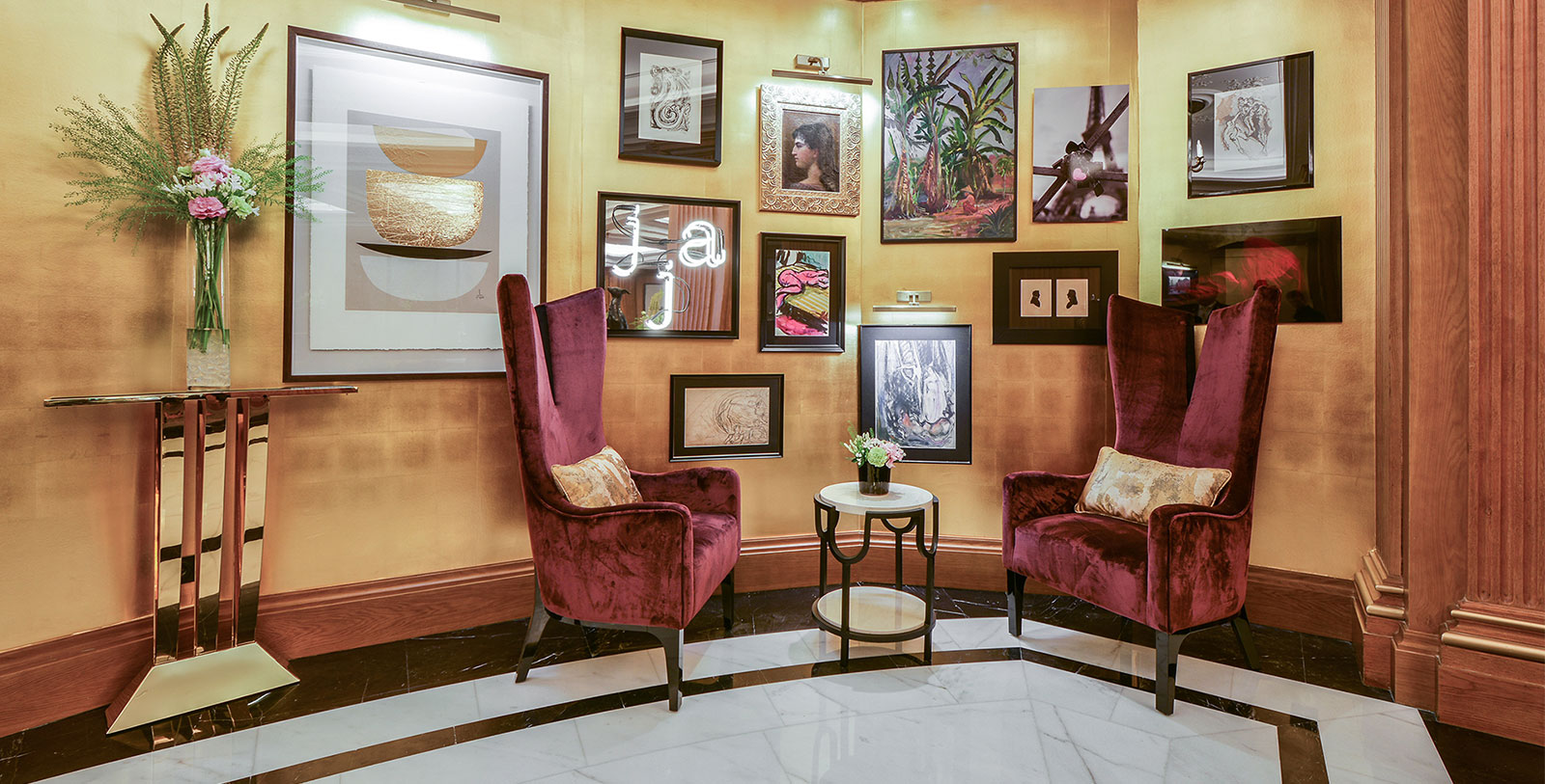 a room with chairs and pictures on the wall