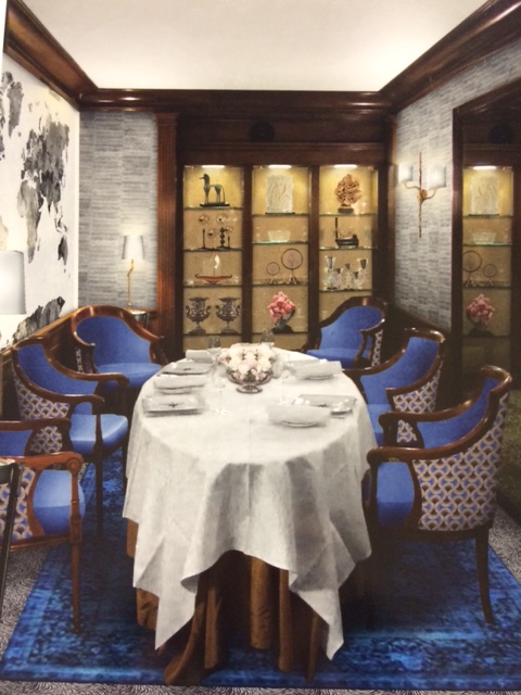 a table with blue chairs and a white tablecloth