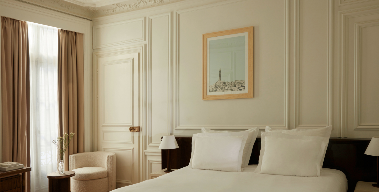 a bed with pillows and a picture on the wall