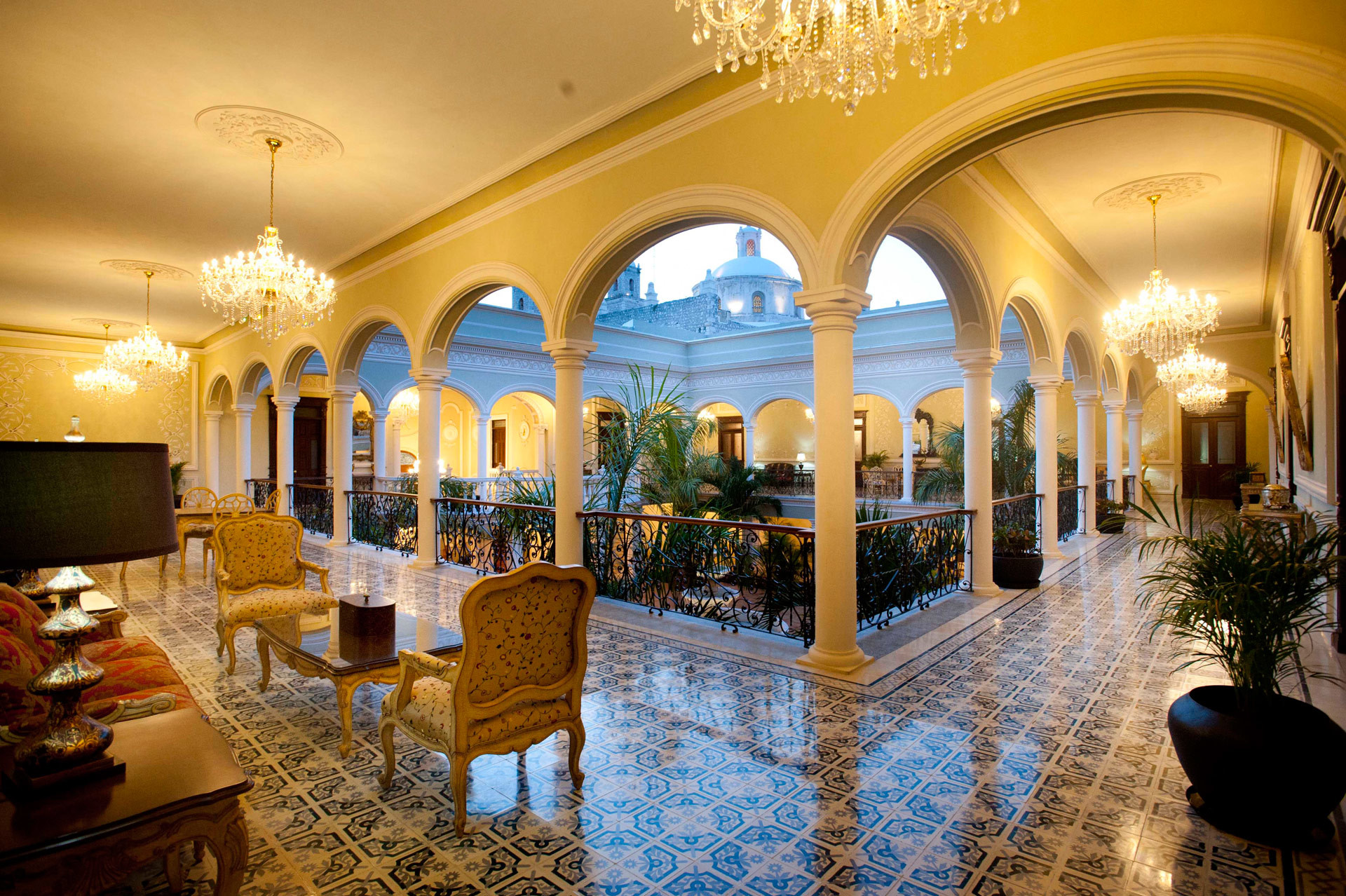 a room with a chandelier and chairs