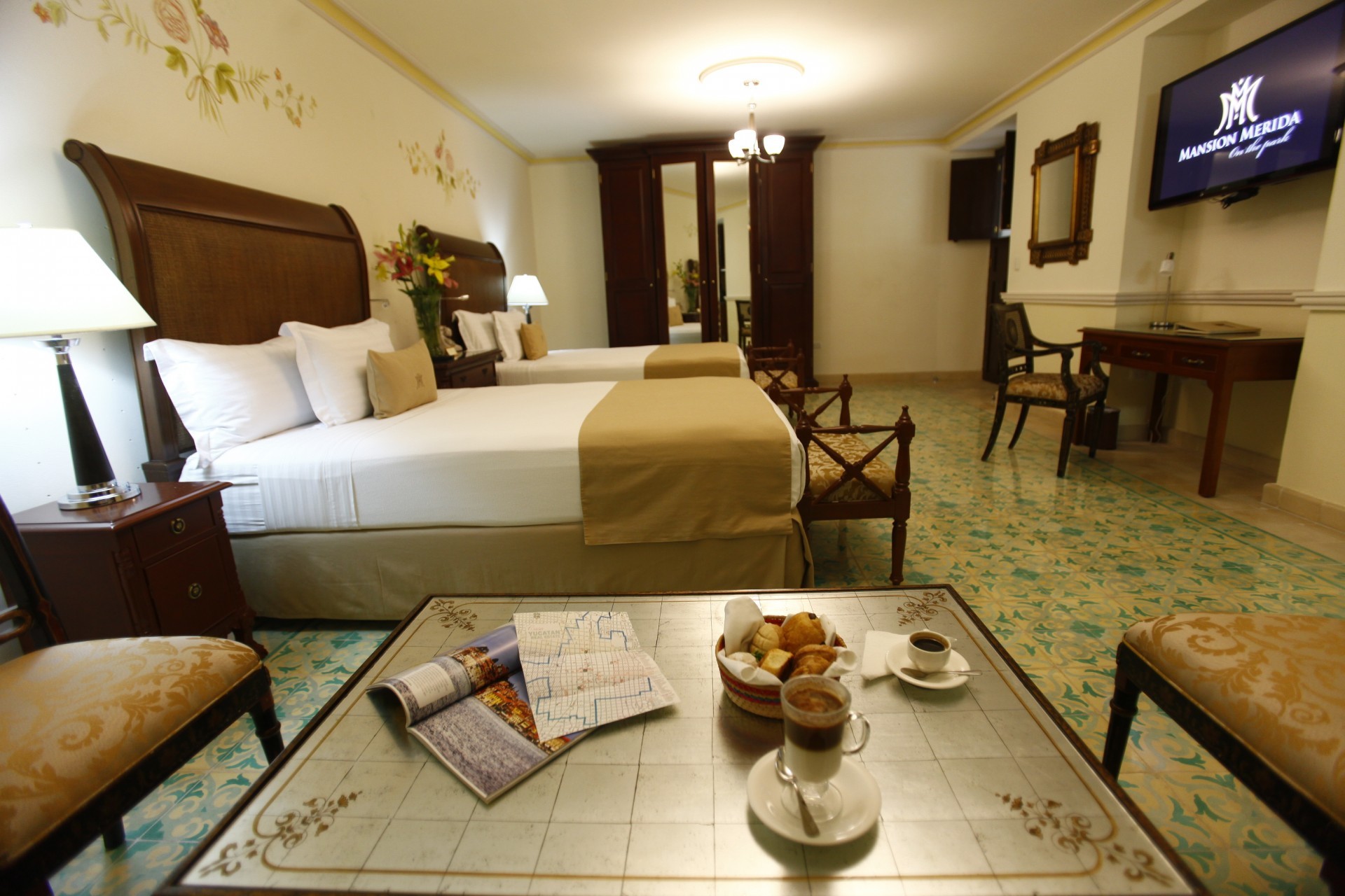 a room with two beds and a coffee table