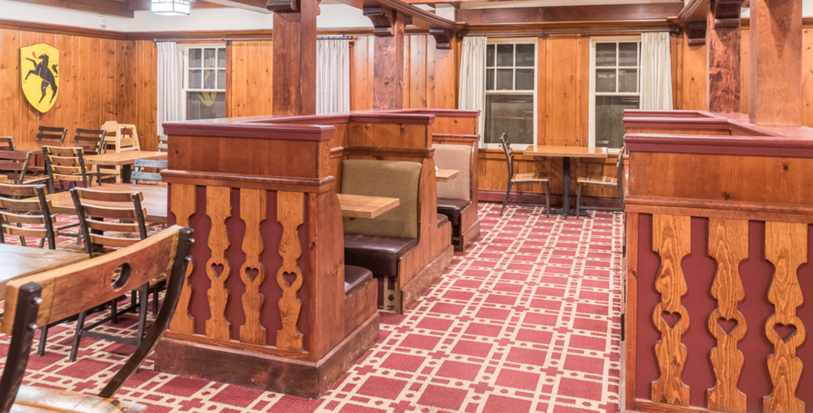 a room with wood walls and a red carpet