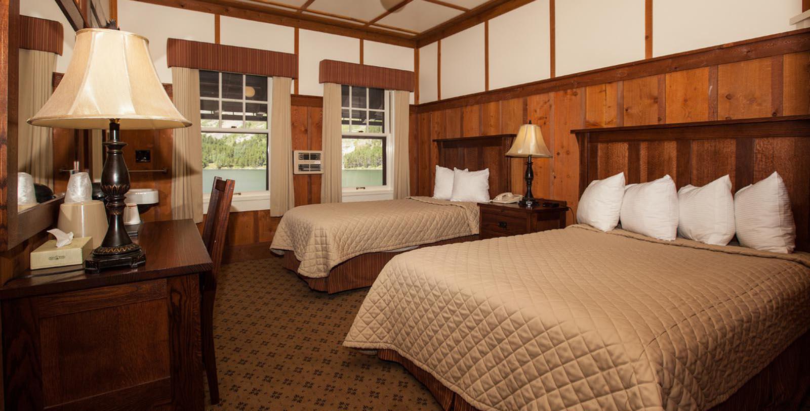 a room with two beds and a table