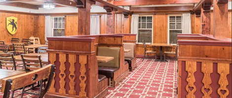 a room with wood paneled walls and a red carpet