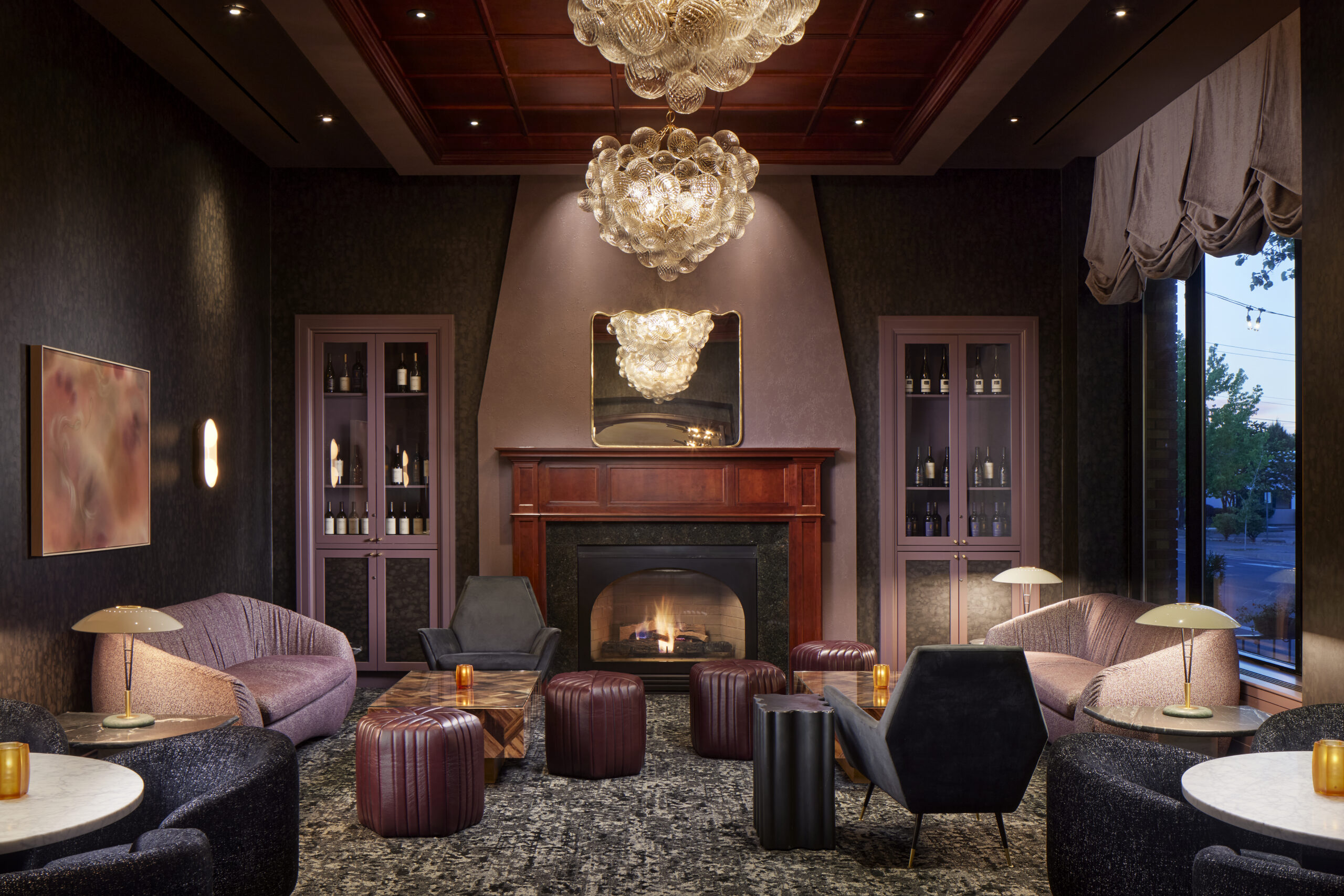a room with a fireplace and chairs