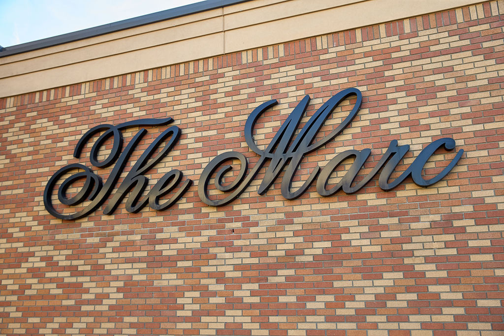 a sign on a brick wall