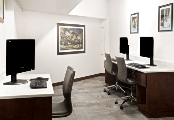 a room with computers and chairs