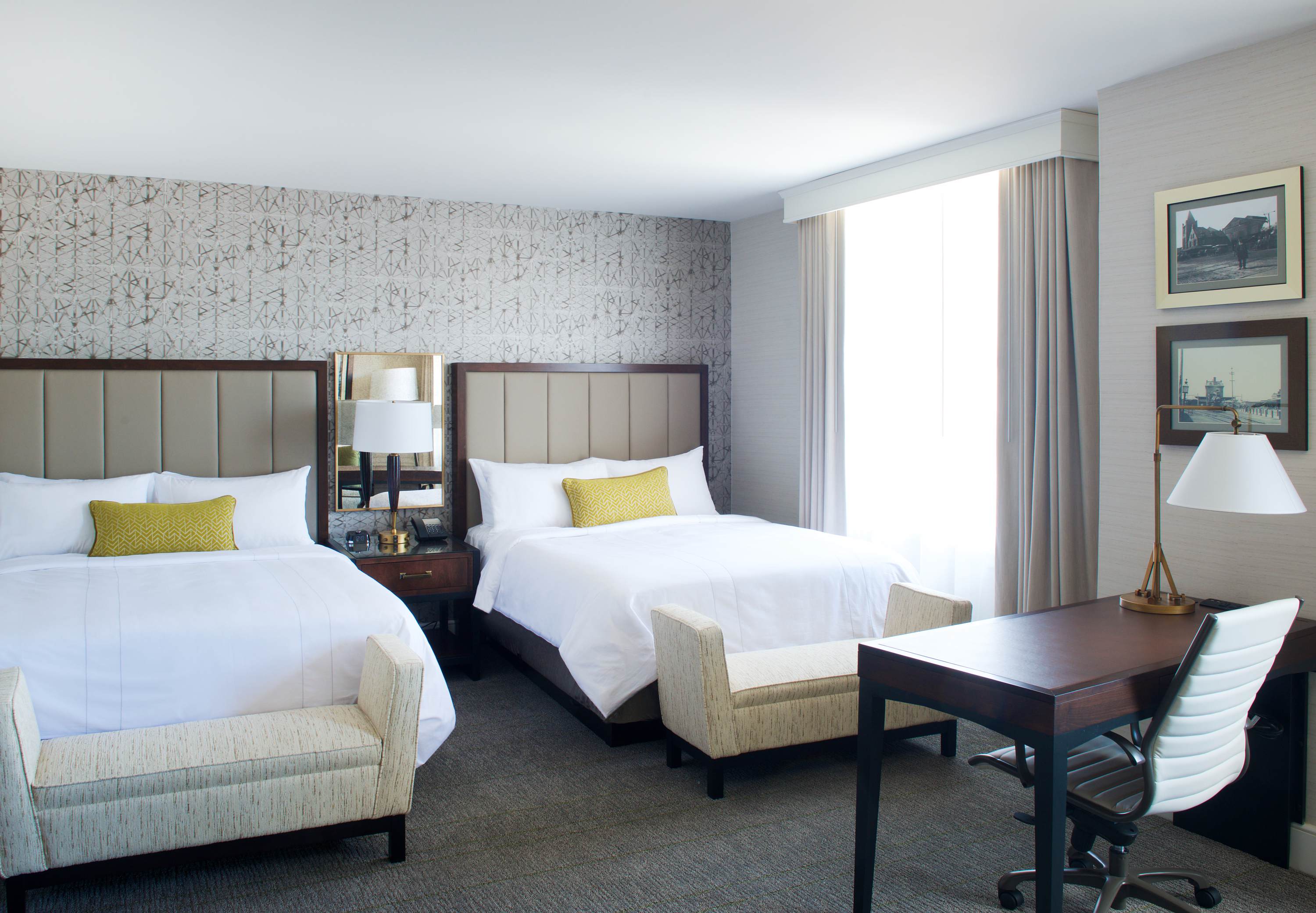 a room with two beds and a desk