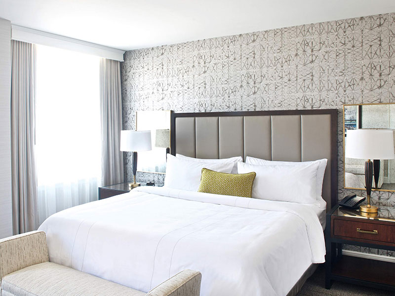 a bed with a lamp and a table in a room