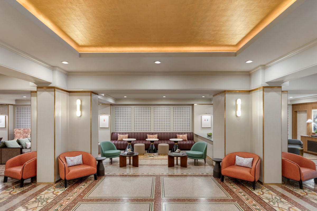 a room with a couch and chairs
