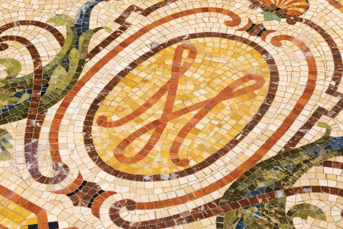a mosaic floor with a letter x