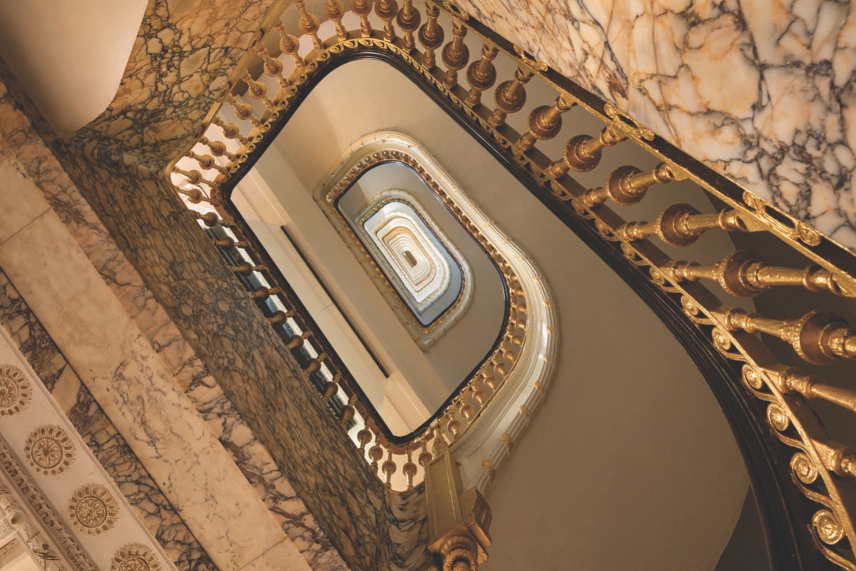 a staircase with a gold railing
