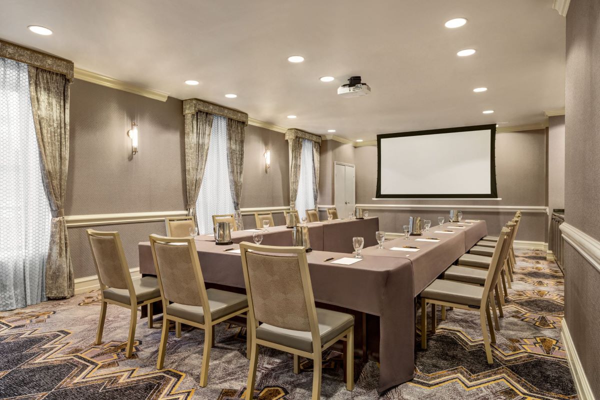 a room with a long table and chairs