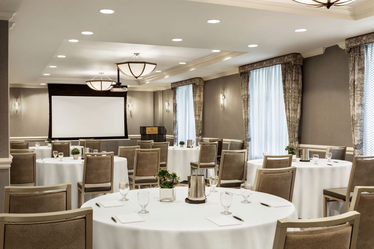 a room with round tables and chairs