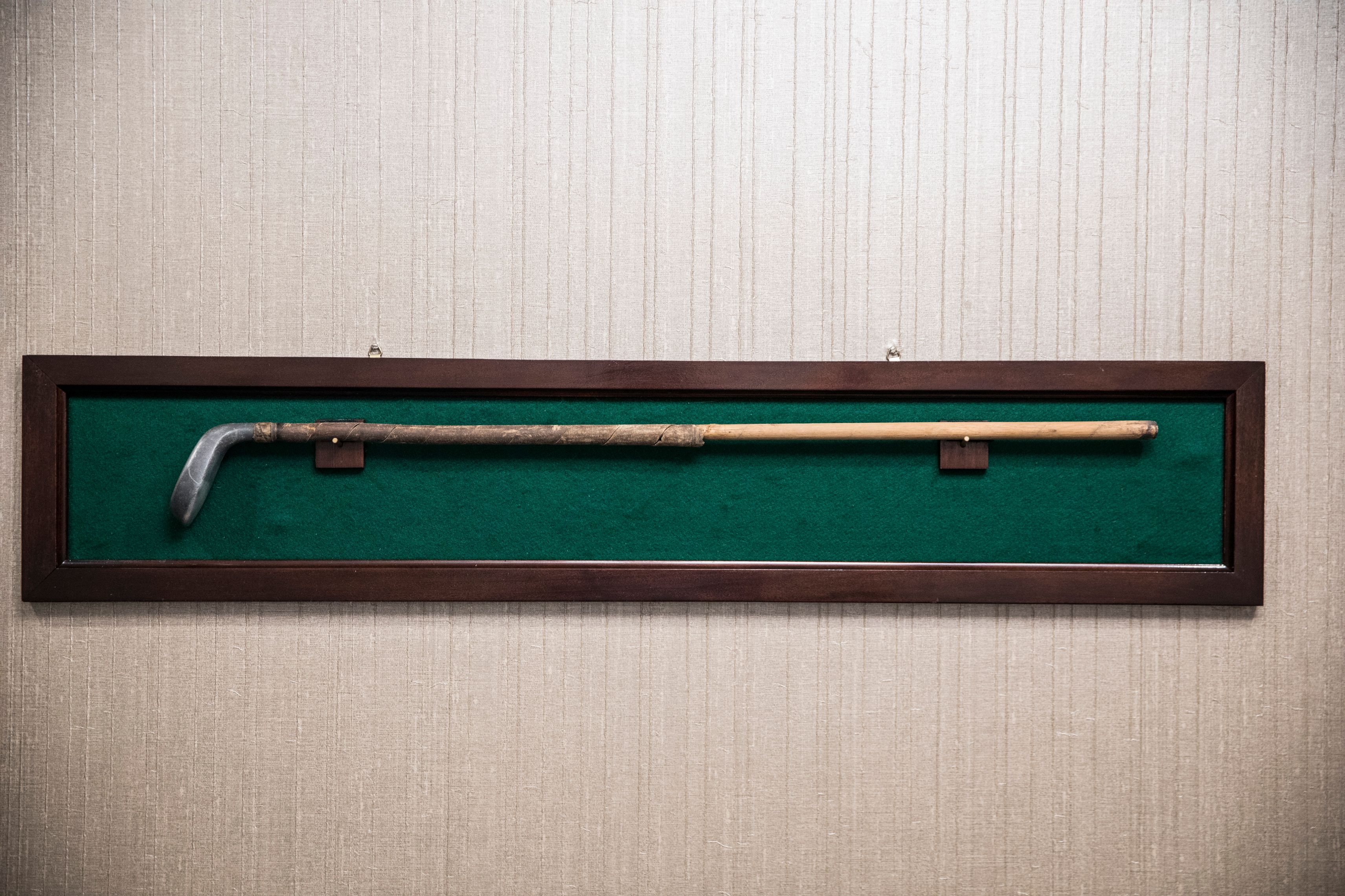 a golf club on a green board