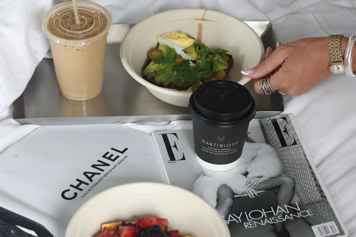 a person holding a cup of coffee and a bowl of food