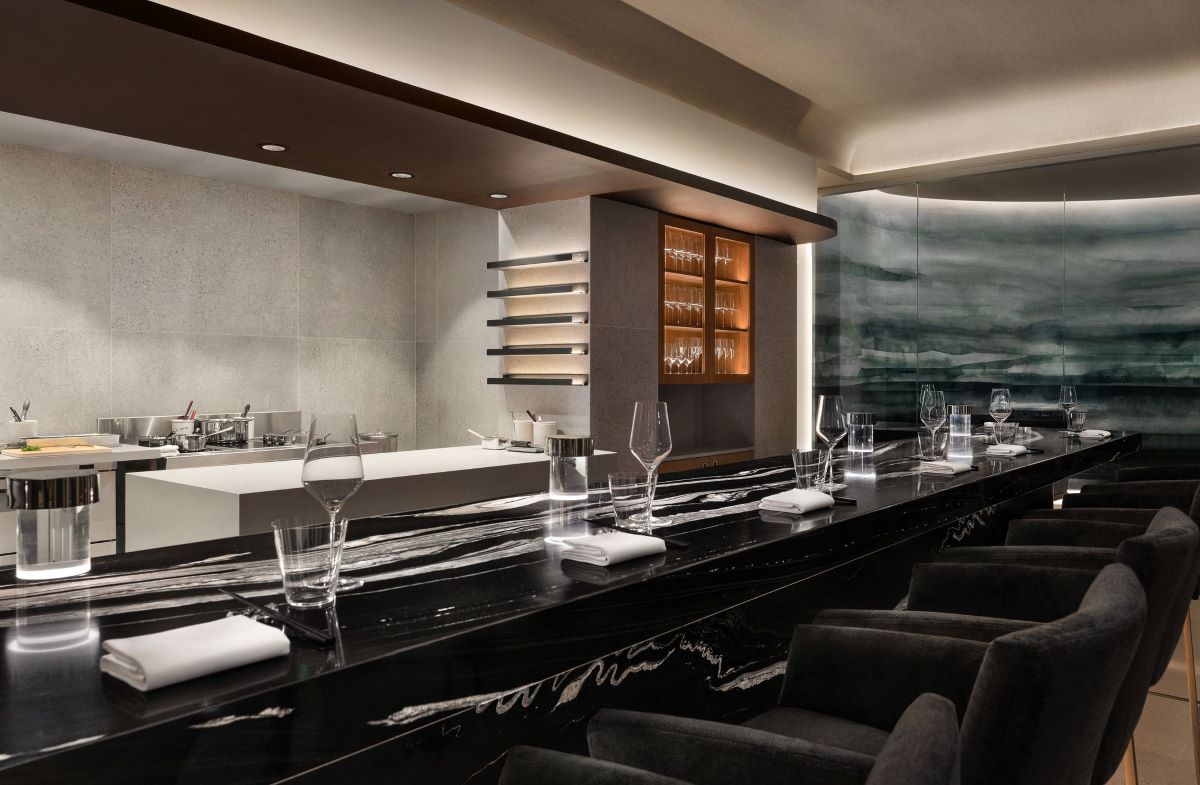 a room with a bar and chairs