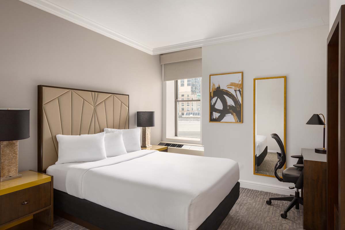 a hotel room with a large mirror and a bed