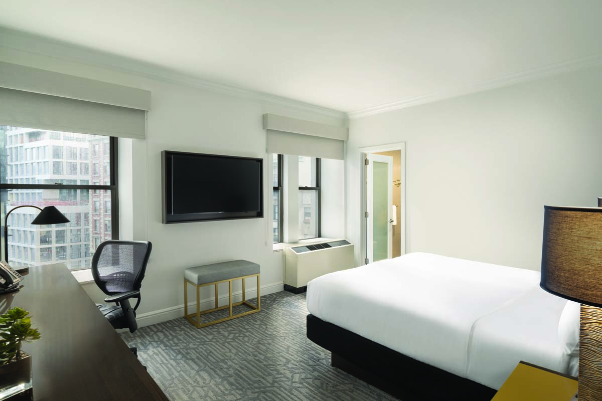 a room with a bed and a tv