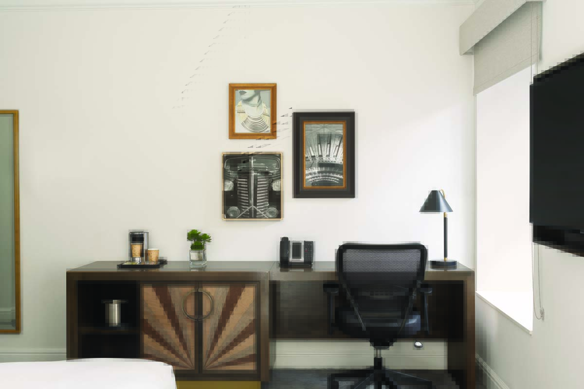 a desk with a chair and a lamp on it