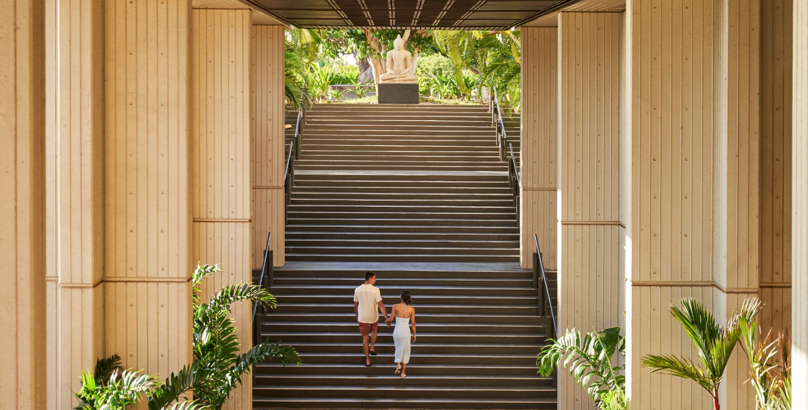 a man and woman walking up stairs