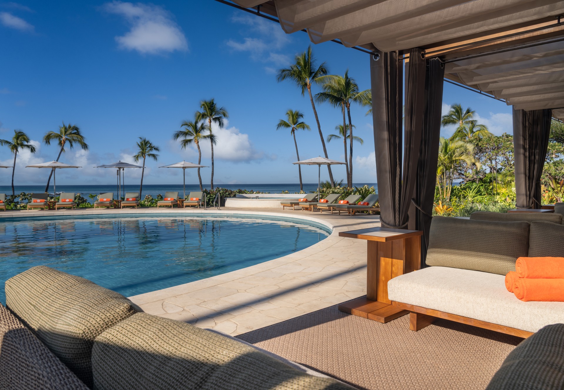 a pool with chairs and umbrellas by it