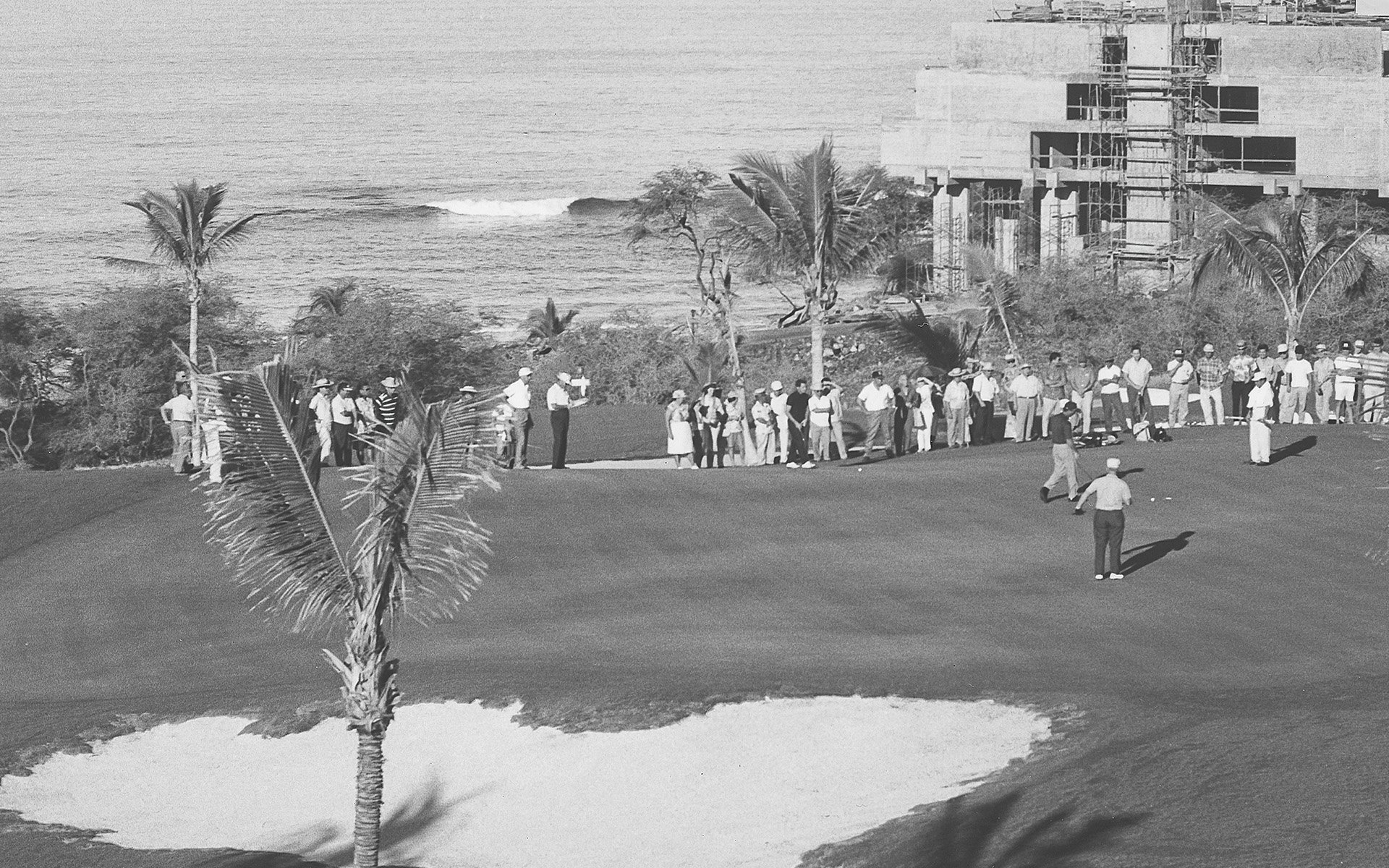 a group of people standing on a golf course