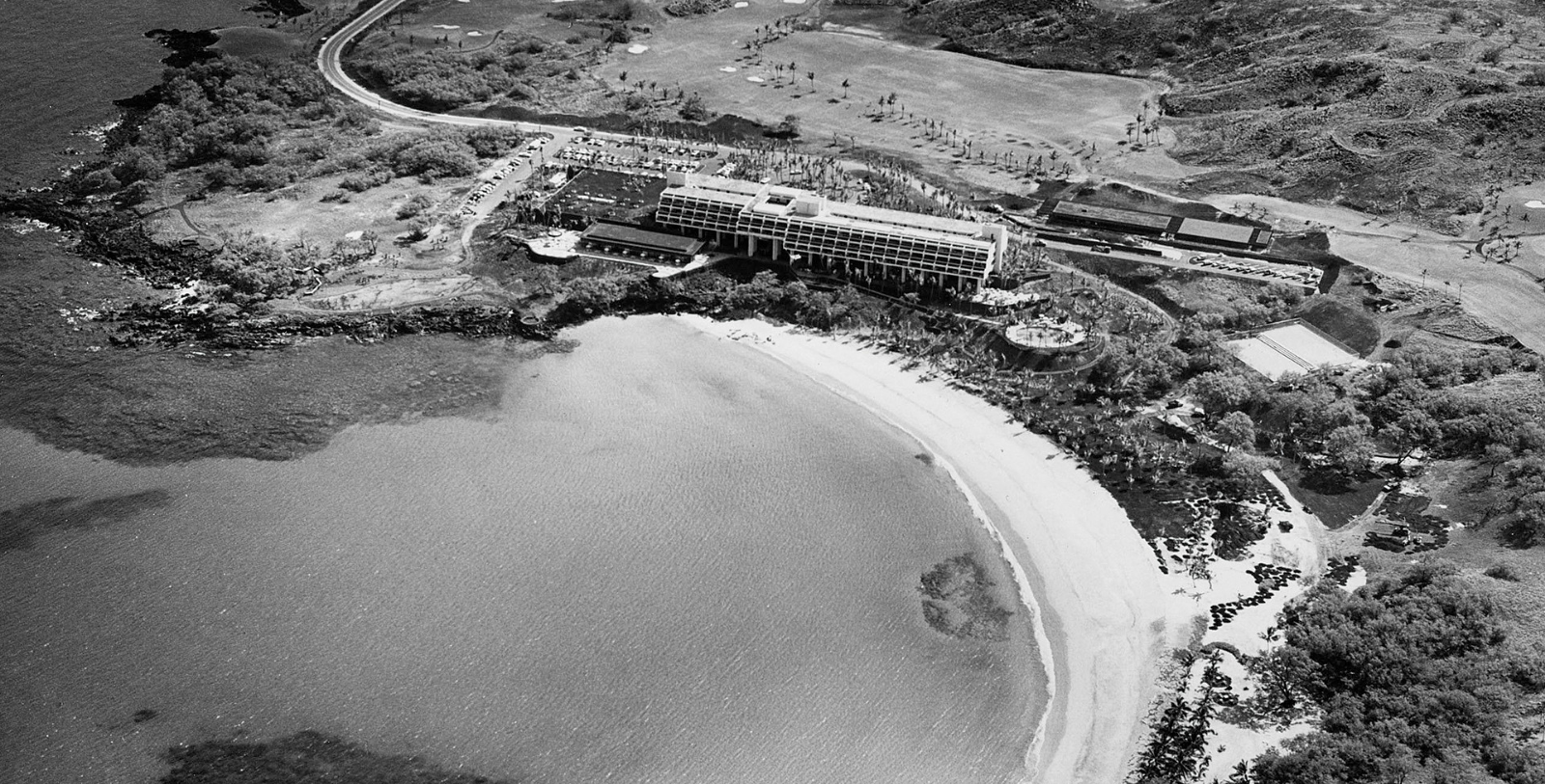 an aerial view of a beach and a building