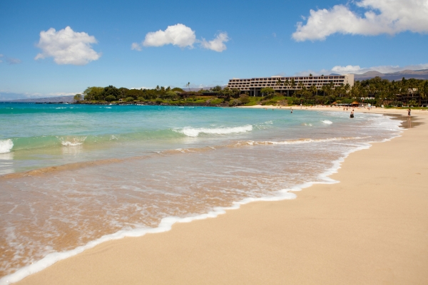 a beach with a building in the background