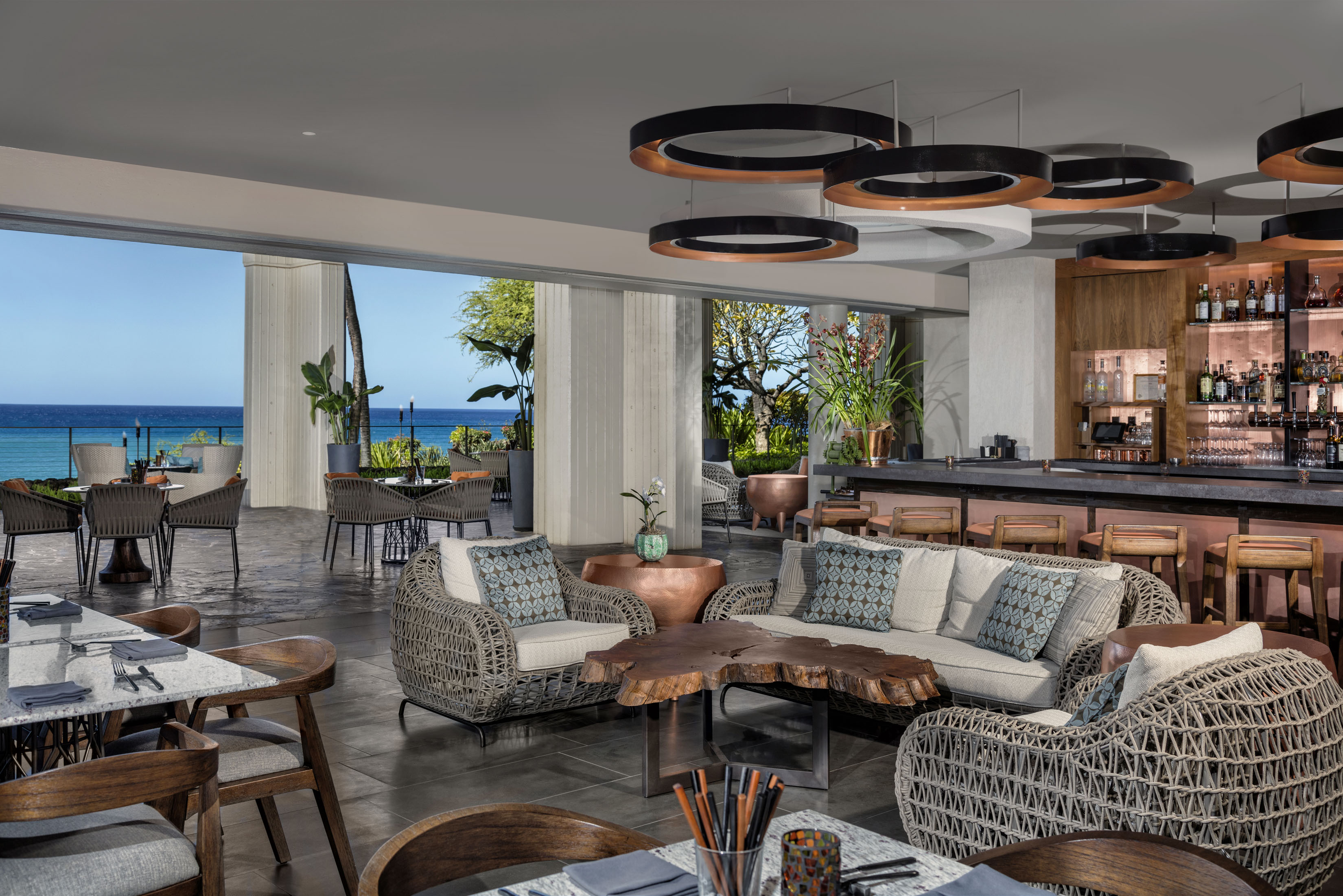 a room with a large table and chairs and a bar