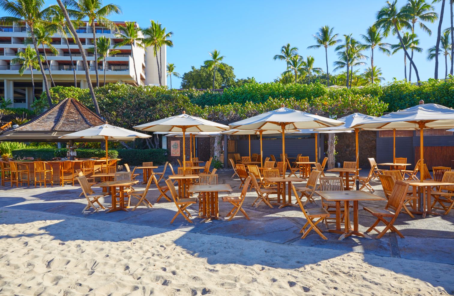 a group of tables and umbrellas on a beach