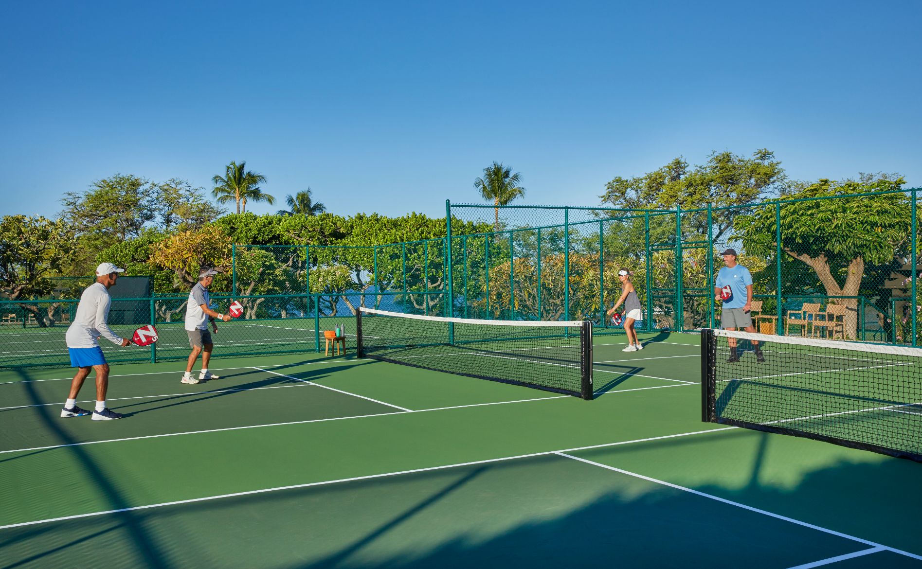 a group of people playing tennis
