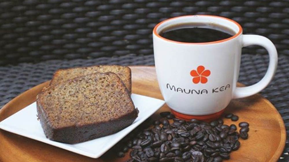 a bread and coffee on a plate