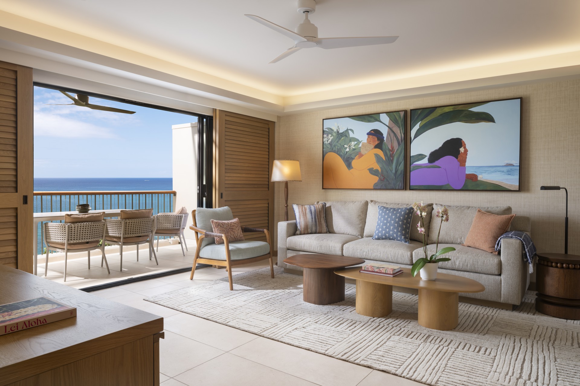 a living room with a couch and chairs and a table