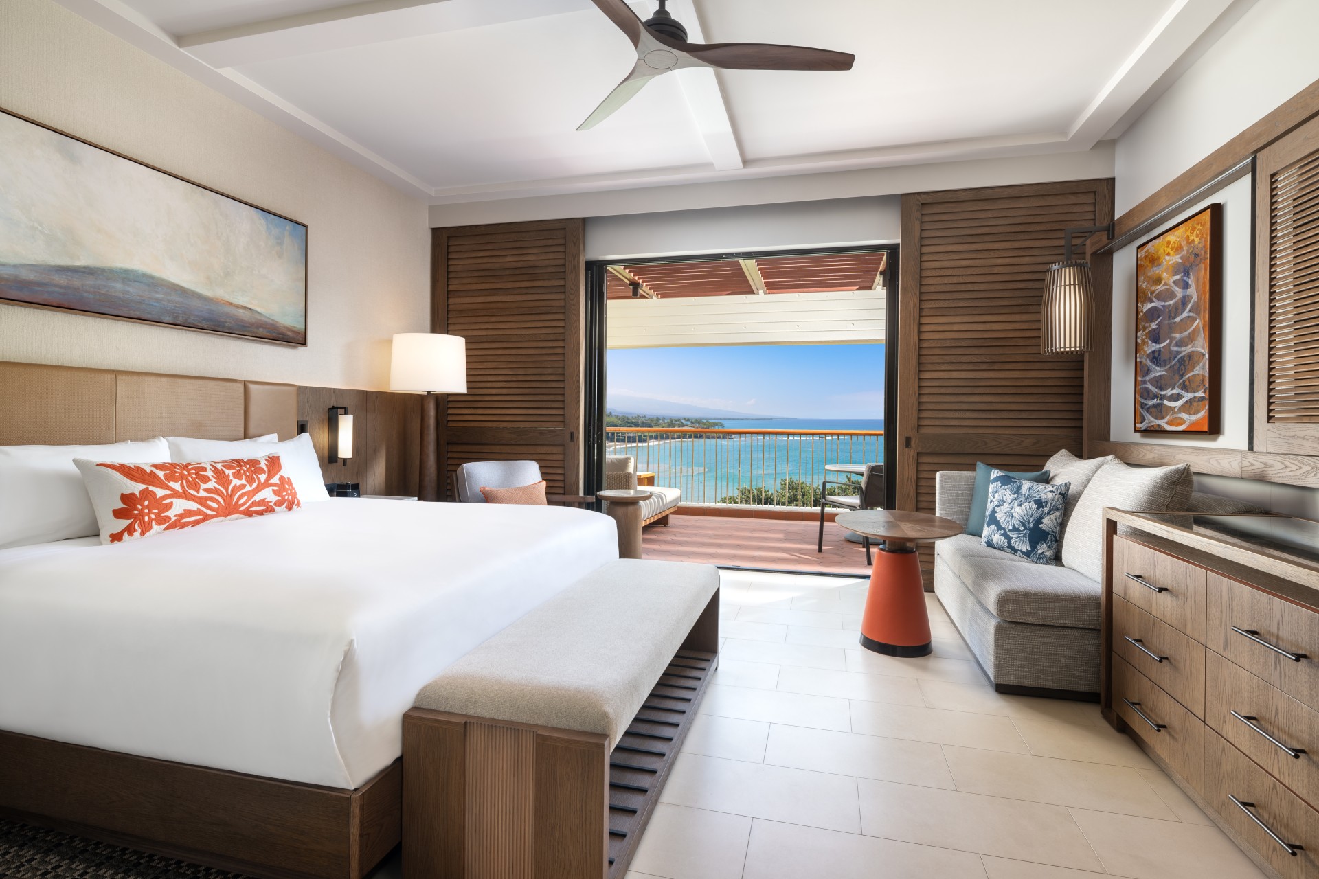 a room with a bed and a couch and a fan