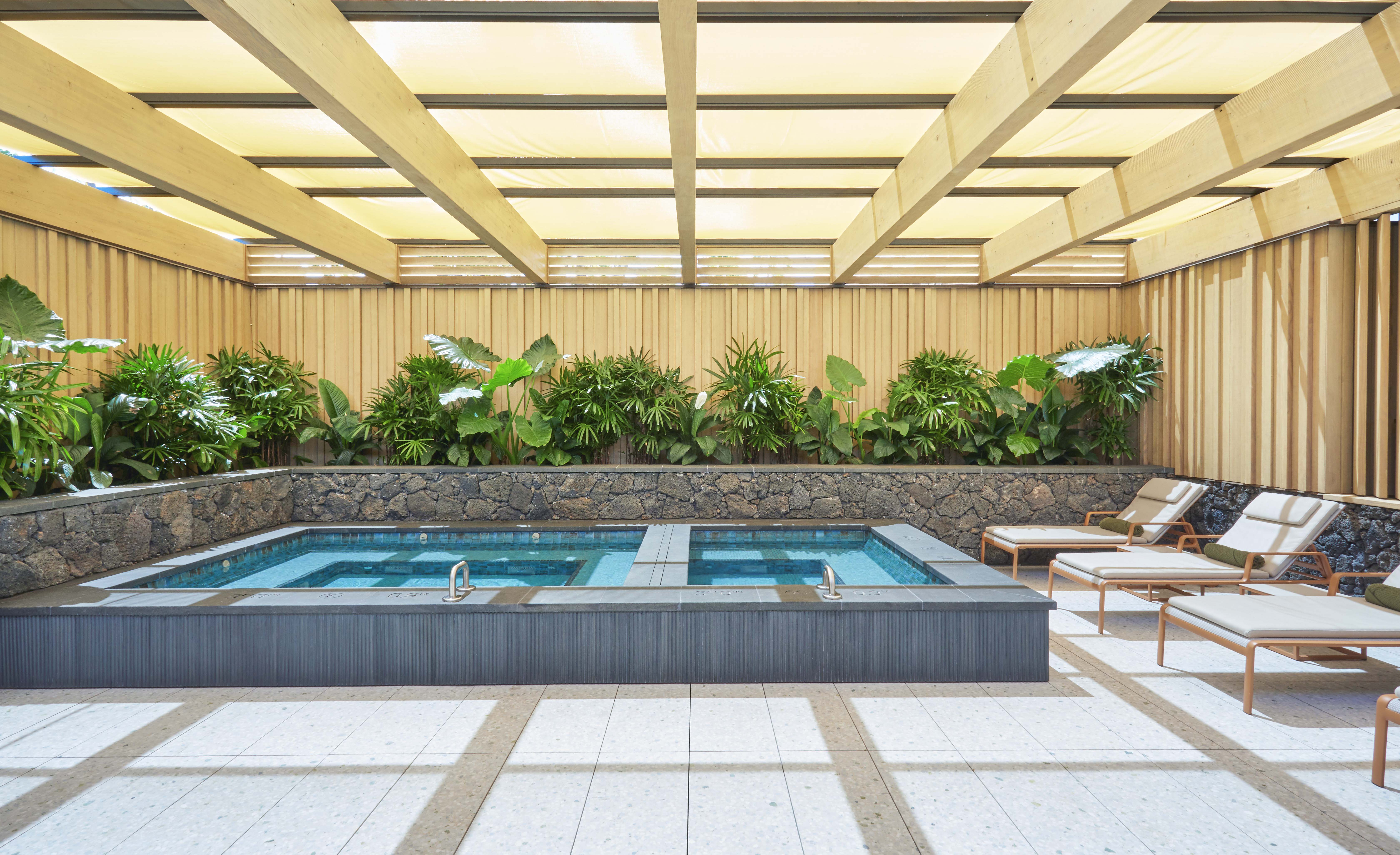 a pool with a deck chair and plants