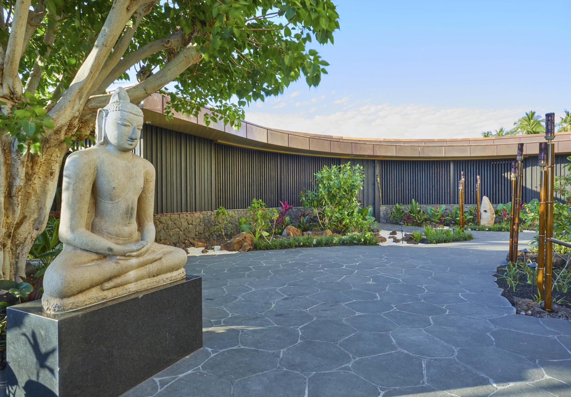 a statue of a man sitting in a lotus position