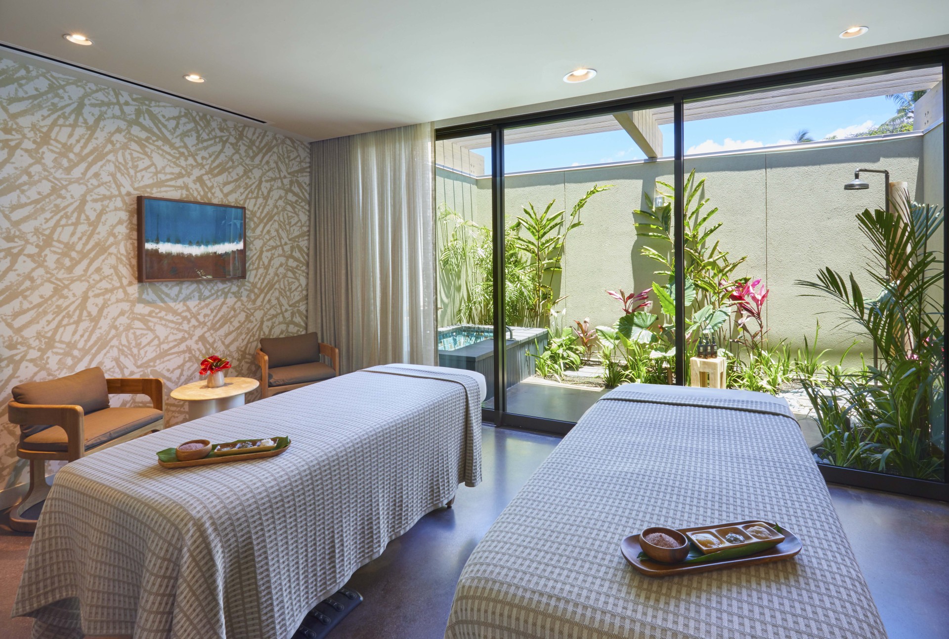 a room with two beds and a pool