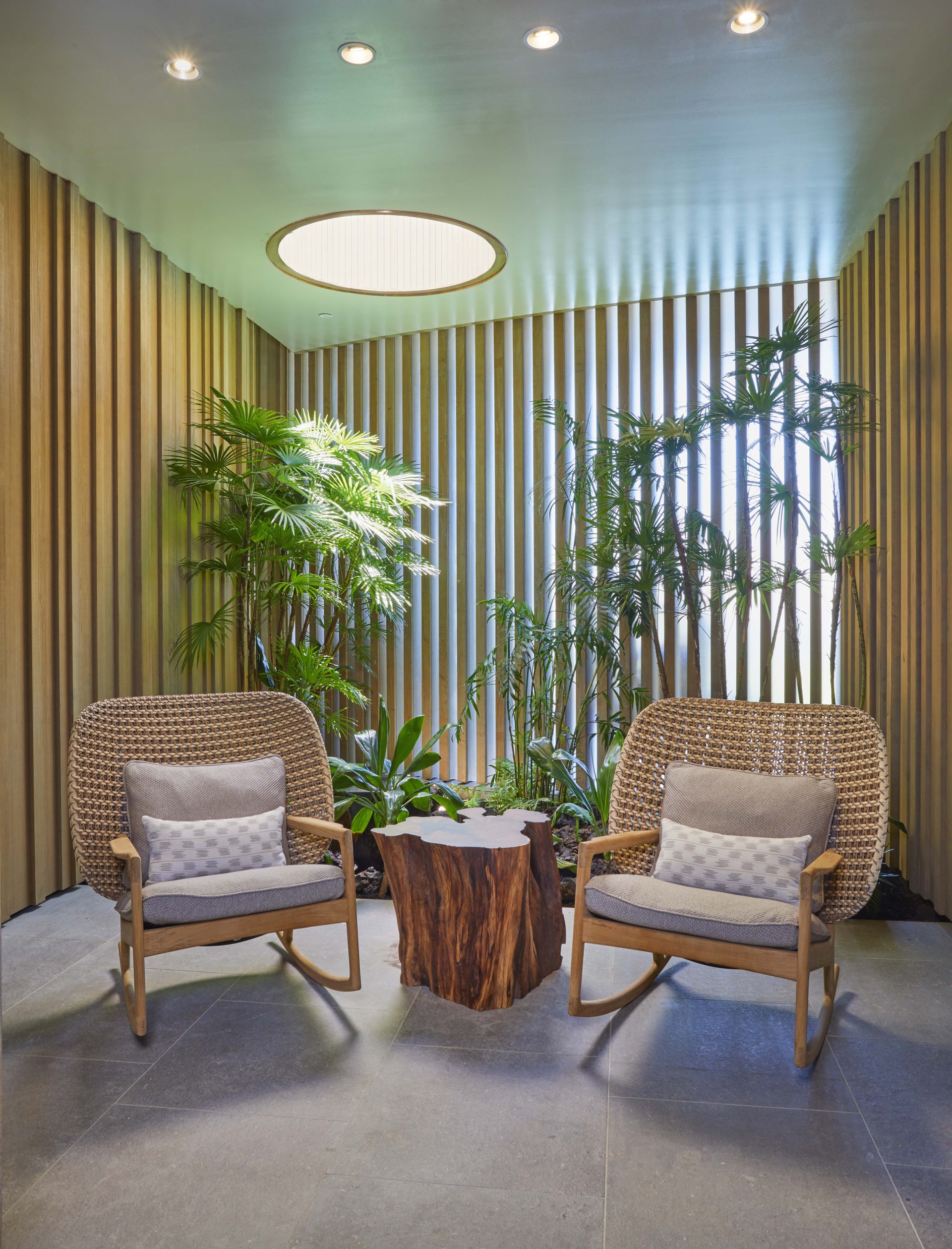 a room with chairs and a tree stump