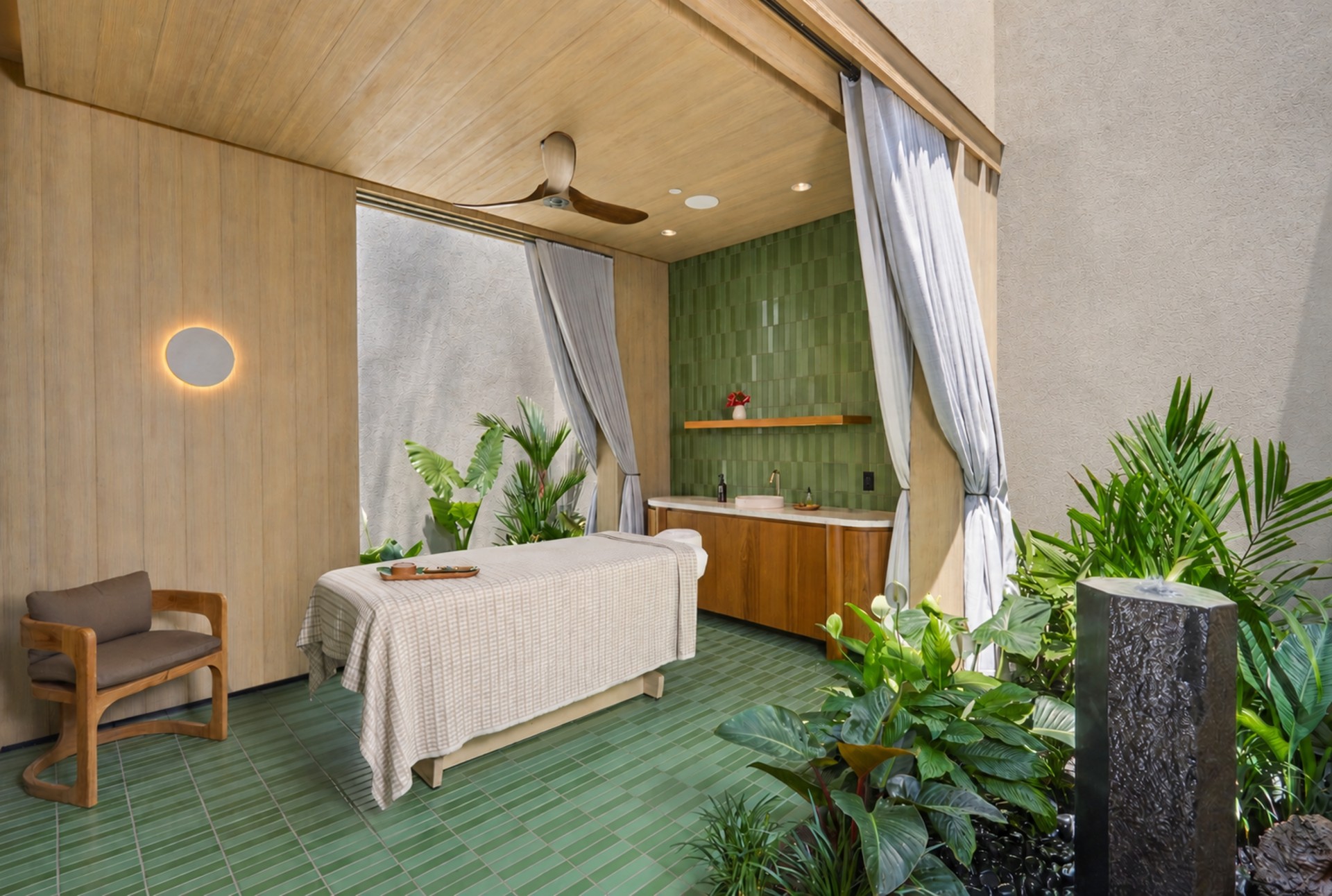 a massage table in a room with plants