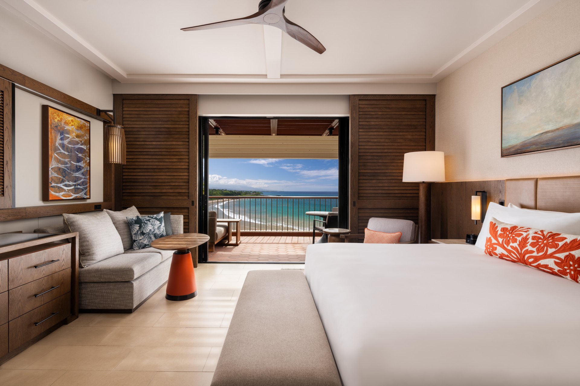 a room with a bed and a couch and a large window