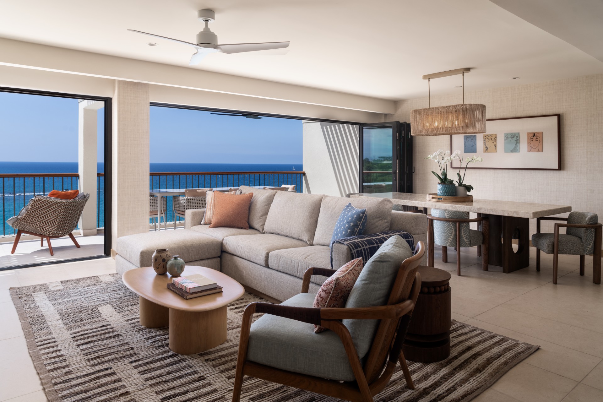 a living room with a large window overlooking the ocean