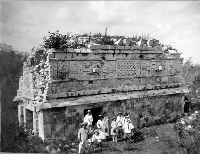 a group of people standing outside of a stone building