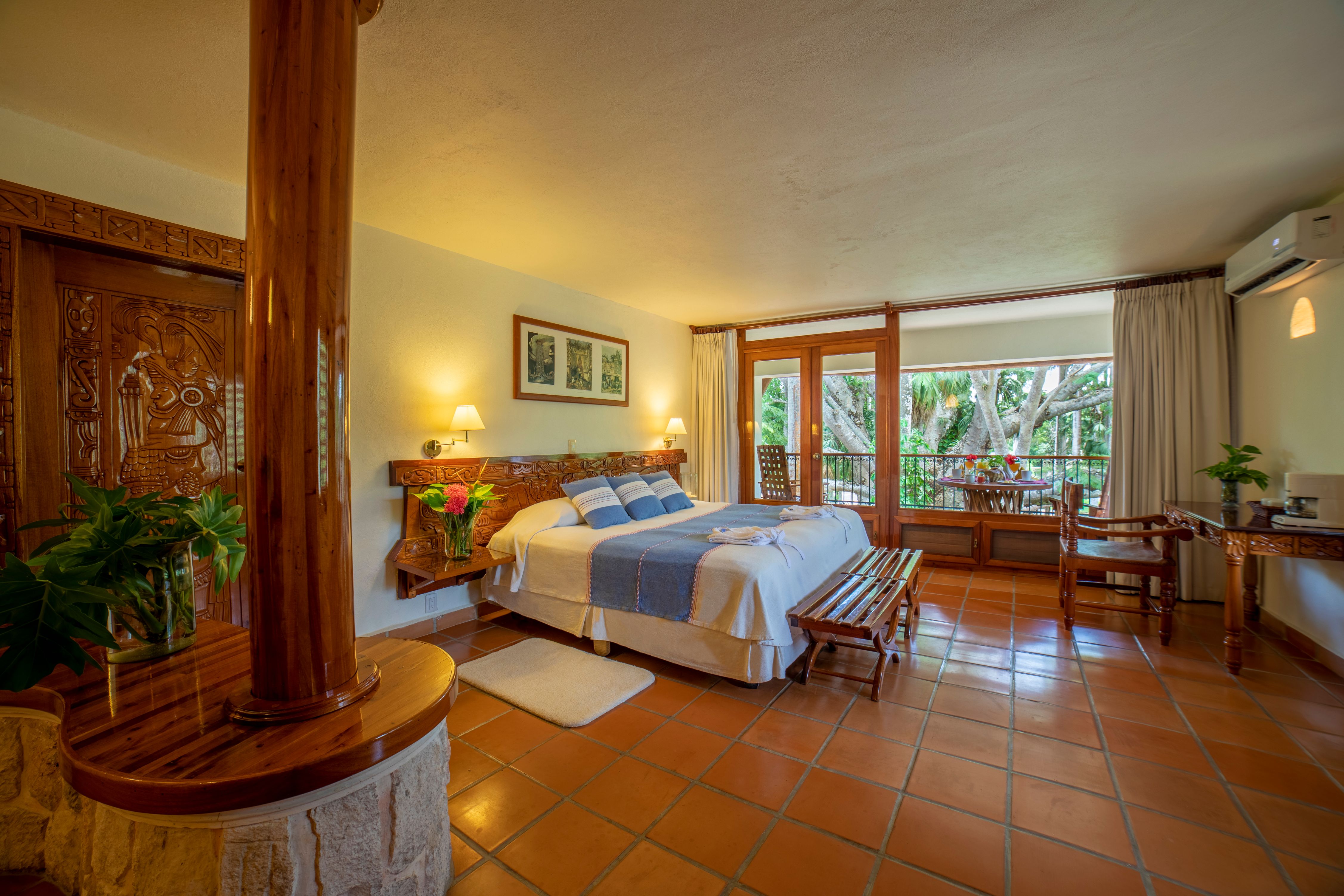 a bedroom with a wood post and a bed