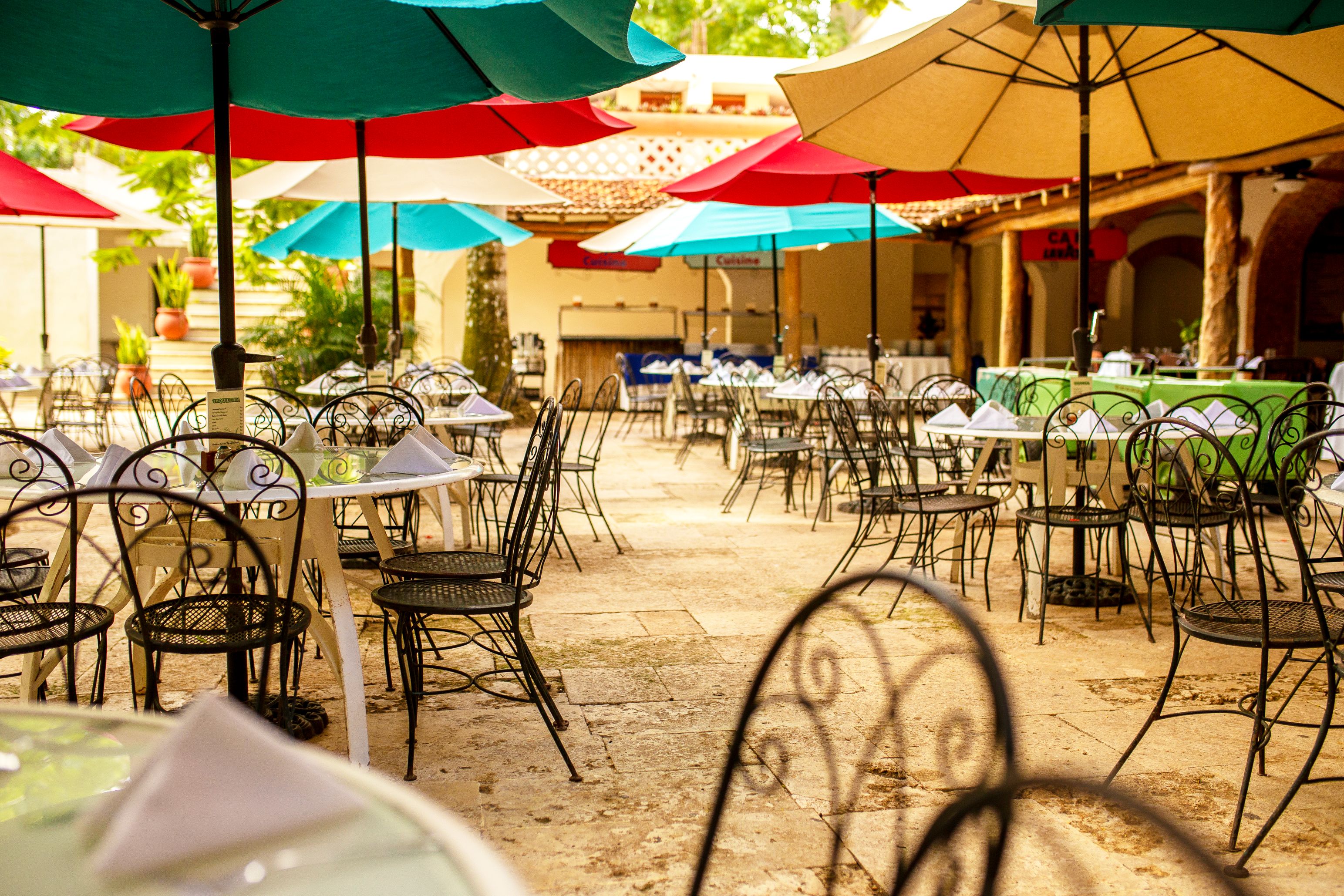 a patio with tables and umbrellas